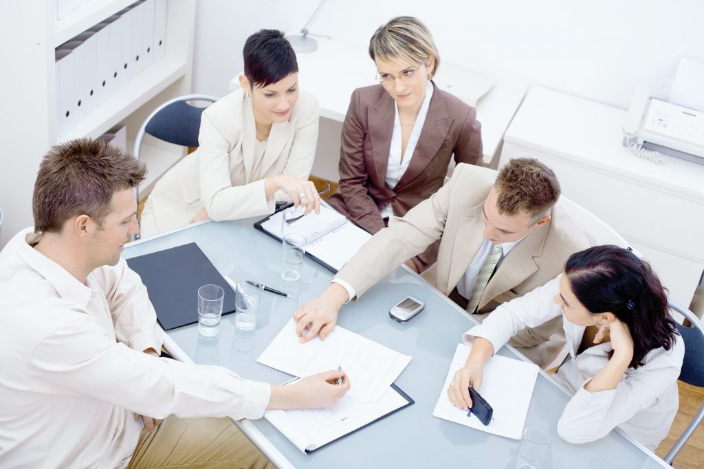 Group of office workers looking at a spreadsheet