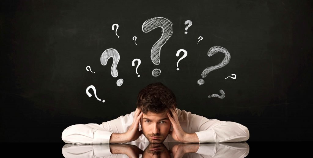 Person looking confused with question marks above their head