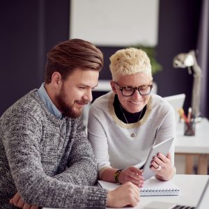 Two people looking at a tablet