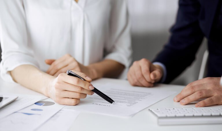Unknown Businessman And Woman Discussing Contract In Office Closeup business People